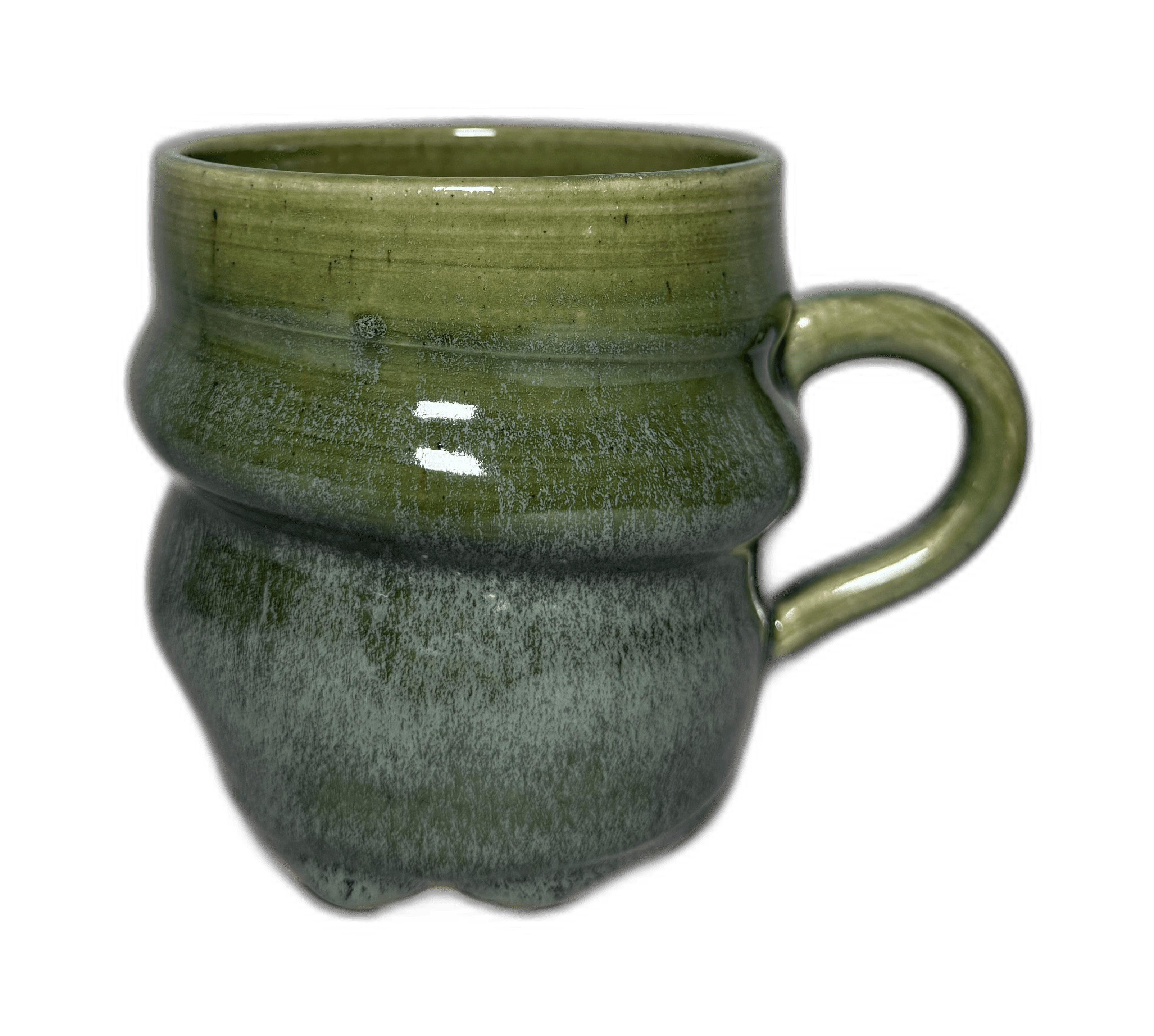 A green-glazed mug photographed on a neutral backdrop